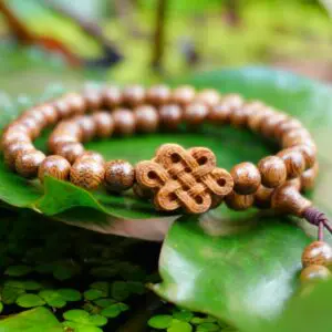Double Agarwood Bracelet 54 beads “Van Phuc” Mixed with the Love Knot Charm (10 – 12 years old agarwood)